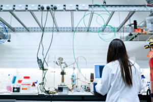 Scientist in lab using a computer - stock image Unsplash