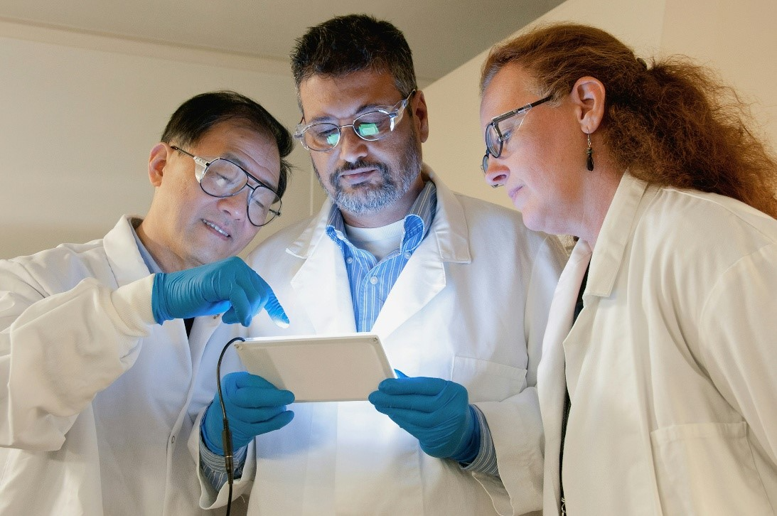 Scientist reviewing findings Scientists reviewing findings via a tablet – stock image Unsplash